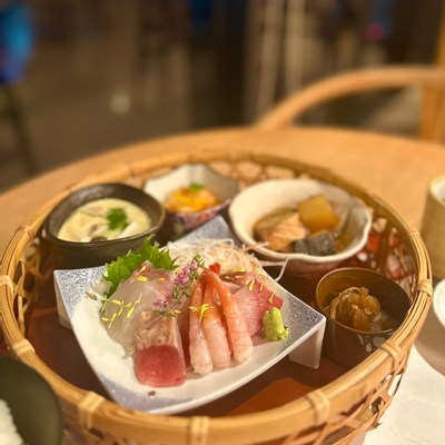 和風のカゴに並んだ刺身と小鉢