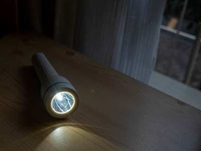 懐中電灯の明かりで停電をしのぐ