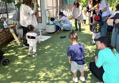 園庭で親子と触れ合うリー先生